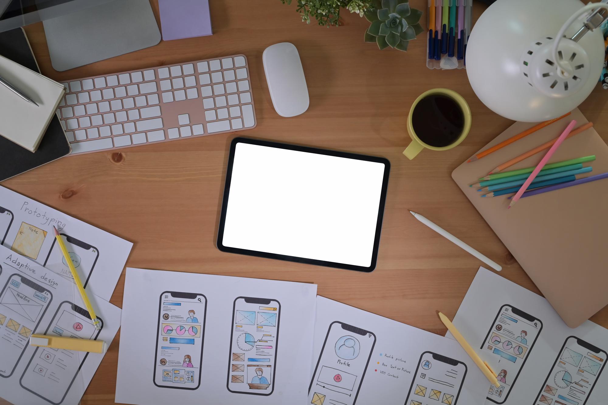 ui wireframes and mockups on desk