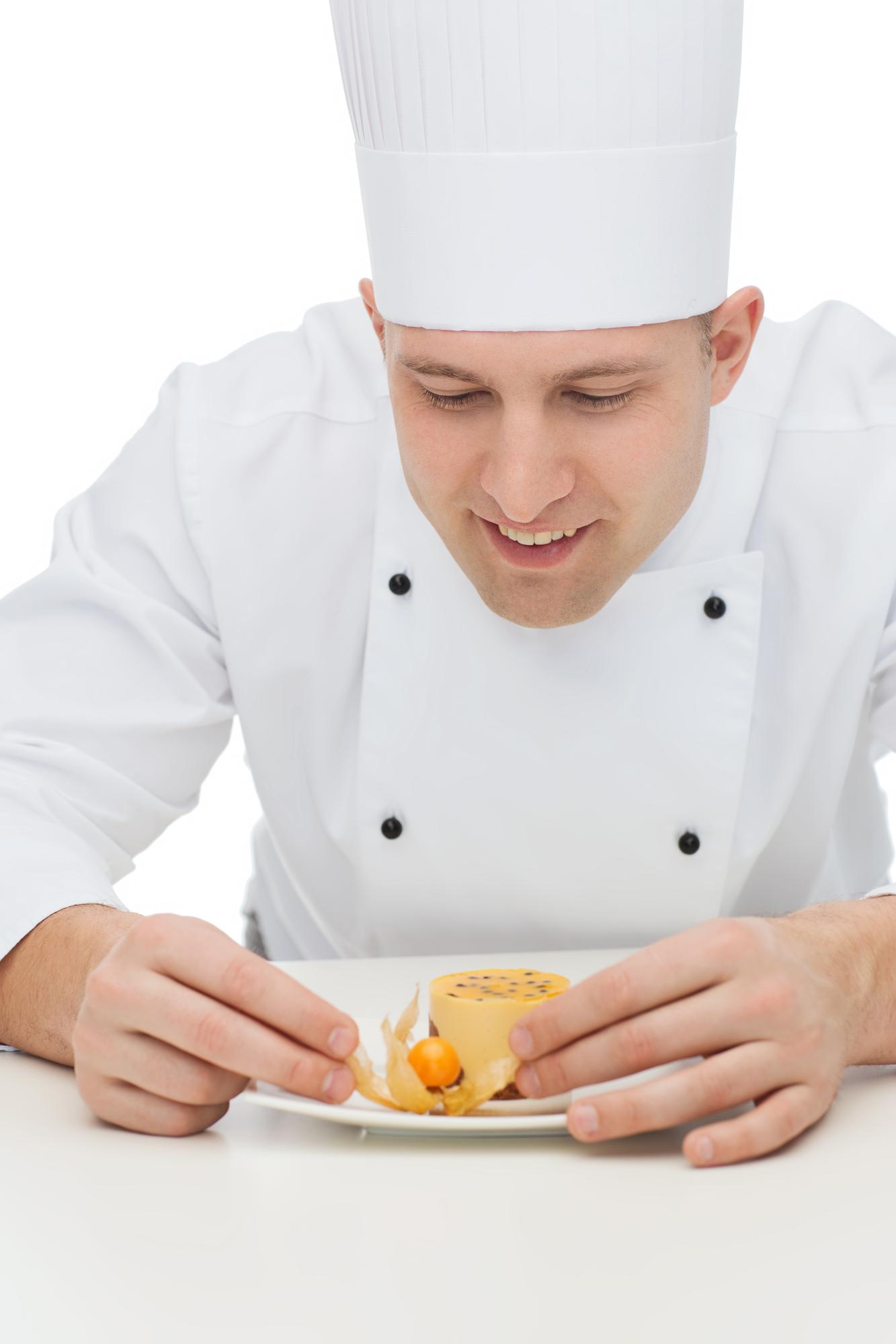 Instructor guiding student plating a dish